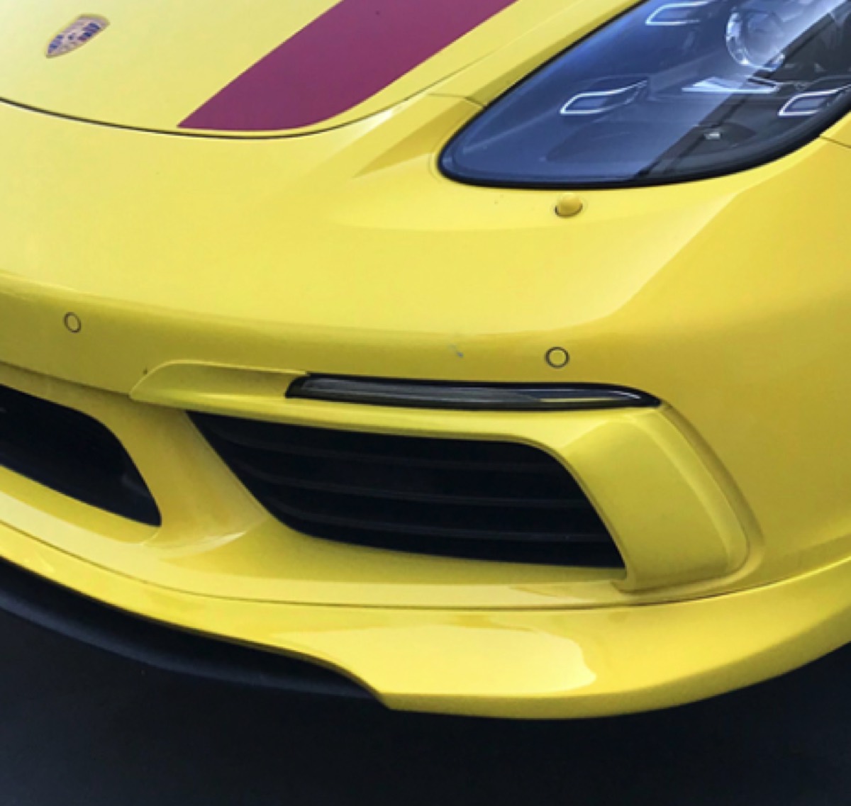 Bumper Crack Repair after in Orange, CA, Cracked and chipped front bumper lip on a Porsche 718, rebuilt, refinished, and color-matched on-site in Orange County.