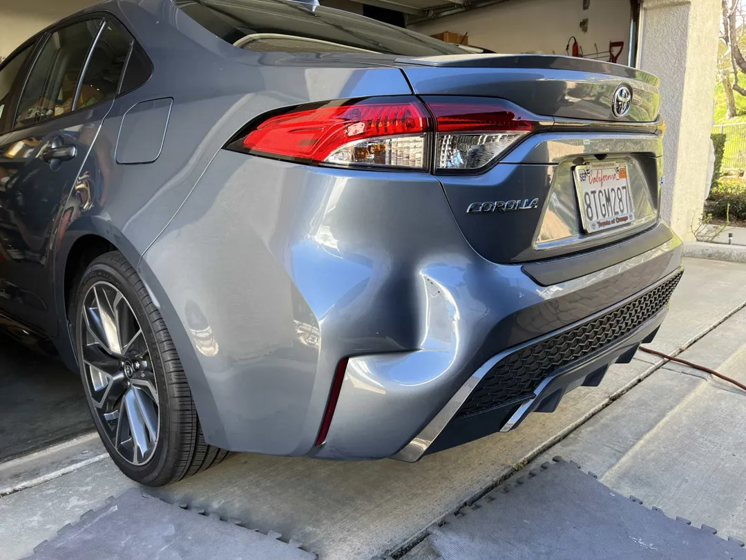 Dent on a vehicle panel before mobile repair in Orange County, CA